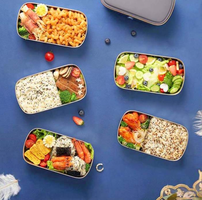 Assorted bento boxes with different meals on a blue background