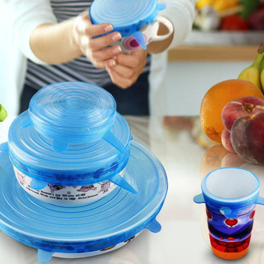 Blue silicone lid on a container with a person holding a colorful cup in a kitchen setting.
